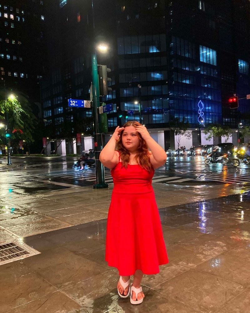 Cricel in a red dress on a city night out