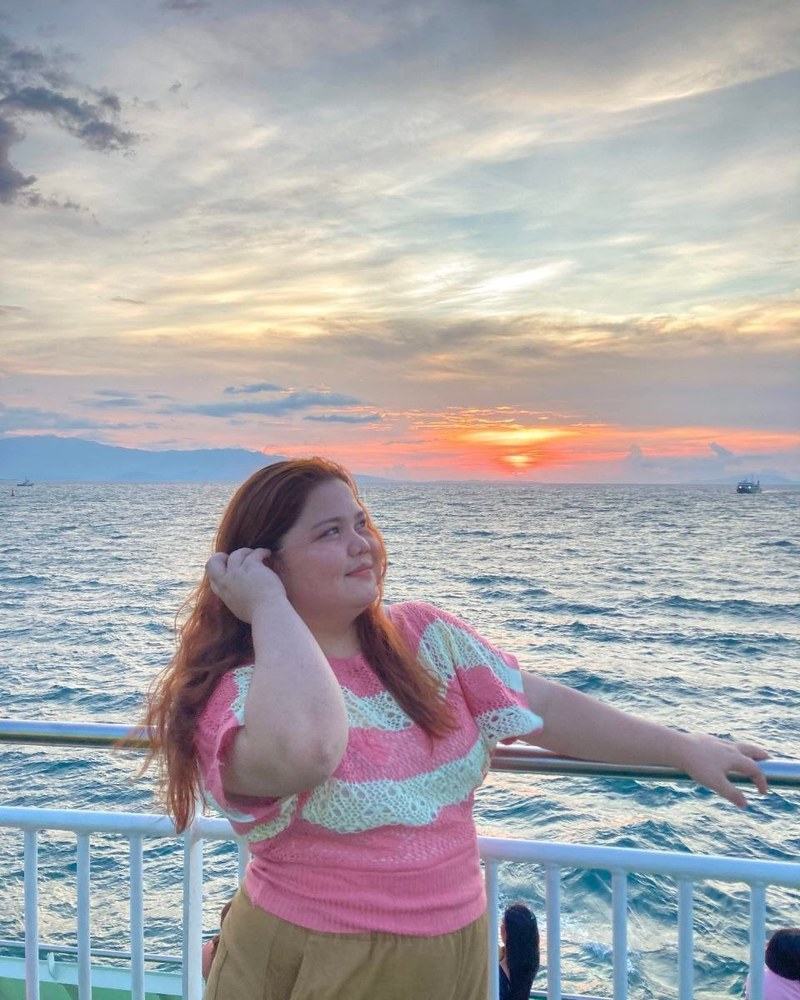 Cricel watching the sunset over the ocean